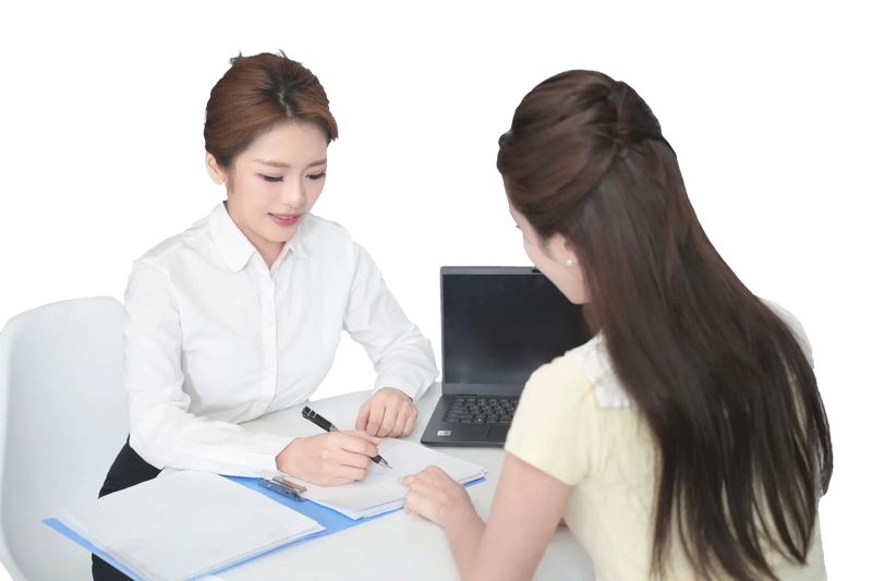 there are money and computers on the table along with models of cars and houses.