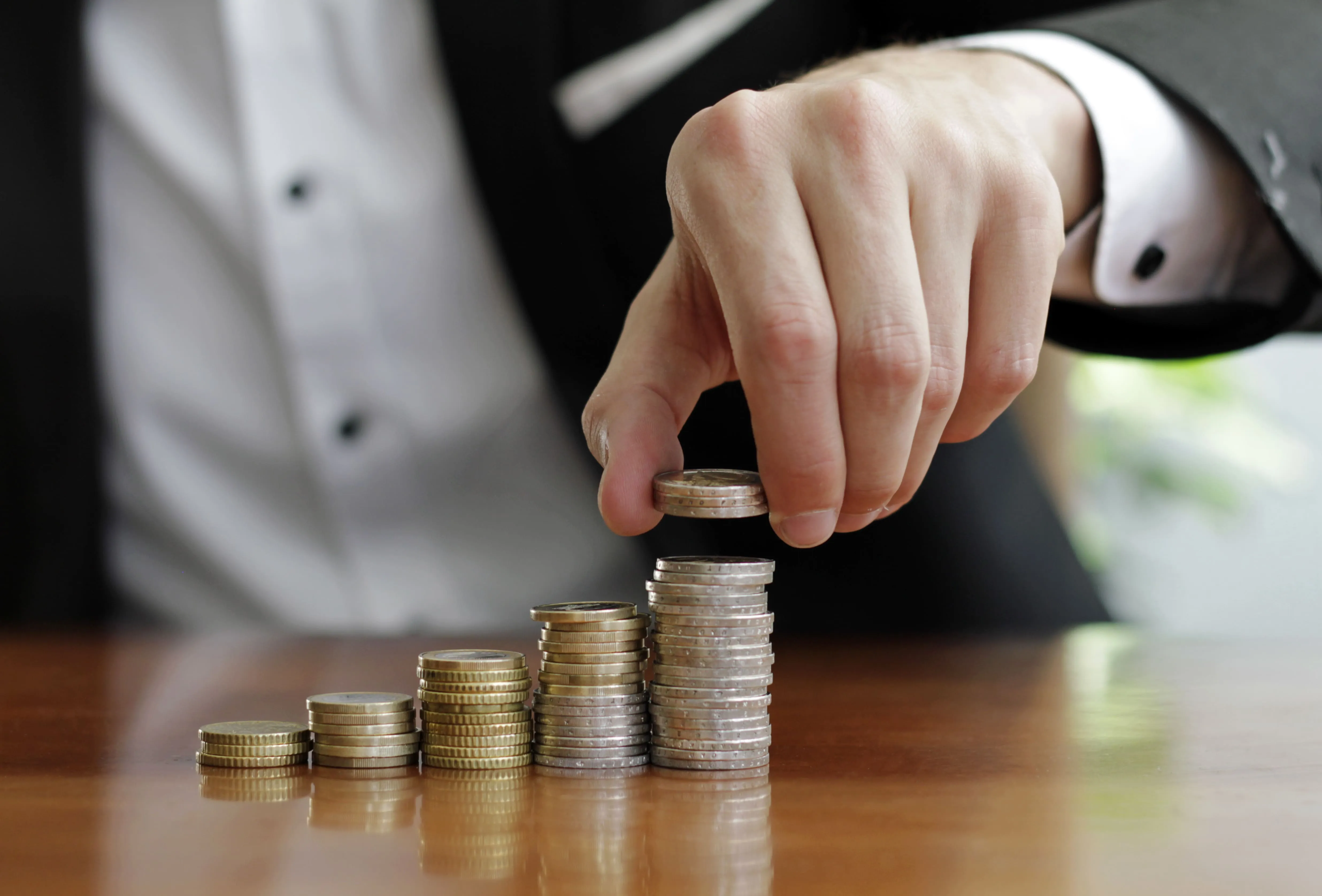 a man is stacking silver coins